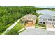 Beautiful aerial view of tan two-story home on a corner lot next to a walking path and lake at 3899 Mount Vernon Way, Kissimmee, FL 34741