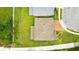 Aerial view of a home with lush lawn, brick roof, and manicured landscaping at 3899 Mount Vernon Way, Kissimmee, FL 34741