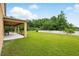 Large backyard with a covered patio and privacy fence at 3899 Mount Vernon Way, Kissimmee, FL 34741