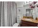 Bright bathroom featuring a granite vanity, tile flooring, and an enclosed shower at 3899 Mount Vernon Way, Kissimmee, FL 34741