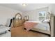 Bedroom with bed, neutral carpet, window, and a dresser with a mirror at 3899 Mount Vernon Way, Kissimmee, FL 34741
