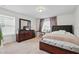 Bright bedroom featuring a window, a dresser, and a bed with a dark brown headboard at 3899 Mount Vernon Way, Kissimmee, FL 34741