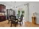 Dining area features a chandelier, sliding glass door, and stylish wood furniture at 3899 Mount Vernon Way, Kissimmee, FL 34741