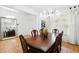 Elegant dining room featuring a large chandelier and an exquisite wooden table with matching chairs at 3899 Mount Vernon Way, Kissimmee, FL 34741