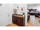 Hallway features a built-in cabinet with granite countertop, decorative accents, and access to the living area at 3899 Mount Vernon Way, Kissimmee, FL 34741