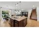 Open-concept kitchen boasts an island, granite counters, pendant lighting, and a seamless transition to living and dining areas at 3899 Mount Vernon Way, Kissimmee, FL 34741