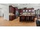 Gourmet kitchen features a large island, granite countertops, stainless steel appliances, and dark wood cabinets at 3899 Mount Vernon Way, Kissimmee, FL 34741