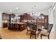 Spacious open-concept kitchen and dining area is showcased with a chandelier and modern appliances at 3899 Mount Vernon Way, Kissimmee, FL 34741
