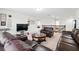 Upstairs living room area featuring dark leather furniture and neutral carpeting throughout at 3899 Mount Vernon Way, Kissimmee, FL 34741