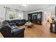 Spacious living room with a comfortable leather sofa and decorative entertainment center at 3899 Mount Vernon Way, Kissimmee, FL 34741
