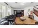 Open-concept living room featuring a dark wood entertainment center and staircase at 3899 Mount Vernon Way, Kissimmee, FL 34741