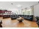 Expansive living room with an oversized leather sofa, tile floors, and adjacent dining area at 3899 Mount Vernon Way, Kissimmee, FL 34741