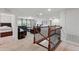 Spacious living room featuring black leather furniture, neutral carpeting, and a staircase at 3899 Mount Vernon Way, Kissimmee, FL 34741