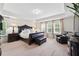 Bright main bedroom features a trey ceiling, plush carpet, and large windows with custom curtains at 3899 Mount Vernon Way, Kissimmee, FL 34741