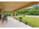 Large covered patio overlooking a beautifully landscaped backyard with lush greenery at 3899 Mount Vernon Way, Kissimmee, FL 34741