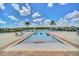 Community pool area with lounge chairs, palm trees, and people enjoying the water at 3899 Mount Vernon Way, Kissimmee, FL 34741