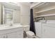Bathroom and laundry room featuring a vanity and sink, toilet and stacked washer and dryer at 411 Sheoah Blvd # 33, Winter Springs, FL 32708