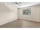 This bedroom features a ceiling fan, light walls and wood-look flooring at 411 Sheoah Blvd # 33, Winter Springs, FL 32708