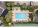 Aerial view of a sparkling community pool surrounded by lounge chairs and lush landscaping at 411 Sheoah Blvd # 33, Winter Springs, FL 32708
