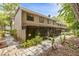 Back exterior view of townhomes with screened-in patios and foliage at 411 Sheoah Blvd # 33, Winter Springs, FL 32708