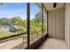 Screened lanai view with tiled floor and foliage, overlooking the parking area at 411 Sheoah Blvd # 33, Winter Springs, FL 32708