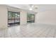 Bright living room features tiled floors and lanai access through sliding doors at 411 Sheoah Blvd # 33, Winter Springs, FL 32708