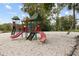 Community playground featuring slides, swings, and climbing structures set in a sandy area at 411 Sheoah Blvd # 33, Winter Springs, FL 32708