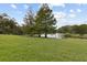 Scenic water view from the community common area, featuring mature trees and green space at 411 Sheoah Blvd # 33, Winter Springs, FL 32708