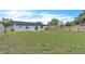 Large, fenced backyard offering plenty of space for recreation and outdoor living; features a grassy lawn at 5627 Marvell Ave, Orlando, FL 32839