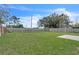Spacious backyard featuring lush lawn, privacy fence, and a concrete slab for outdoor enjoyment and entertaining at 5627 Marvell Ave, Orlando, FL 32839