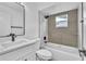 Modern bathroom with white vanity, new fixtures, and tiled shower and tub at 5627 Marvell Ave, Orlando, FL 32839
