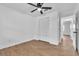 Bedroom with wood-look floors, a ceiling fan, and a closet with louvered doors at 5627 Marvell Ave, Orlando, FL 32839