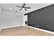Clean, modern bedroom with stylish accent wall and ceiling fan at 5627 Marvell Ave, Orlando, FL 32839