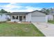 Charming single-story home featuring a well-maintained lawn and an attached two car garage at 5627 Marvell Ave, Orlando, FL 32839