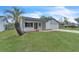 Lovely home with a well-manicured lawn and mature landscaping including a palm tree at 5627 Marvell Ave, Orlando, FL 32839