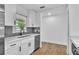 Bright kitchen features white cabinets, stainless steel appliances and a window view at 5627 Marvell Ave, Orlando, FL 32839