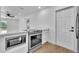 Modern kitchen with stainless steel appliances, white cabinets and light countertops at 5627 Marvell Ave, Orlando, FL 32839