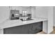 Modern kitchen island with a white quartz countertop, dark cabinetry and stainless appliances at 5627 Marvell Ave, Orlando, FL 32839