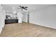 Open concept living room with kitchen bar, sleek wood floors, and recessed lighting at 5627 Marvell Ave, Orlando, FL 32839