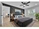 Well-lit main bedroom with stylish accent wall, ceiling fan, and a view to outdoors at 5627 Marvell Ave, Orlando, FL 32839