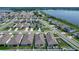 Aerial view capturing a lakeside community with numerous houses and a stunning water backdrop at 591 Lake Smart Blvd, Winter Haven, FL 33881