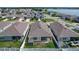 An aerial view displays a neighborhood featuring well-maintained homes and picturesque lake views at 591 Lake Smart Blvd, Winter Haven, FL 33881