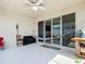 Covered back patio with ceiling fan, a hammock, and sliding glass doors leading inside at 591 Lake Smart Blvd, Winter Haven, FL 33881