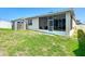 Well-maintained backyard with green grass, a storage shed, and a screened lanai at 591 Lake Smart Blvd, Winter Haven, FL 33881
