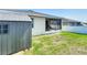 Backyard featuring screen lanai, storage shed, and green lawn space at 591 Lake Smart Blvd, Winter Haven, FL 33881