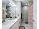 Bright bathroom featuring double sinks, quartz countertops, and a decorative shower curtain at 591 Lake Smart Blvd, Winter Haven, FL 33881