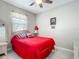 Cozy bedroom featuring a ceiling fan, a picture window, and wicker furniture at 591 Lake Smart Blvd, Winter Haven, FL 33881