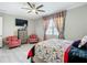 Charming bedroom featuring wood-look tile flooring, a ceiling fan, and plenty of natural light at 591 Lake Smart Blvd, Winter Haven, FL 33881