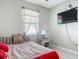 Cozy bedroom featuring a ceiling fan, a picture window, and wicker furniture at 591 Lake Smart Blvd, Winter Haven, FL 33881