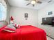 Cozy bedroom featuring a ceiling fan, a picture window, and wicker furniture at 591 Lake Smart Blvd, Winter Haven, FL 33881